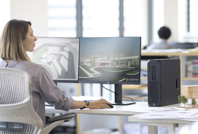 a lady is working with a workstation in an office