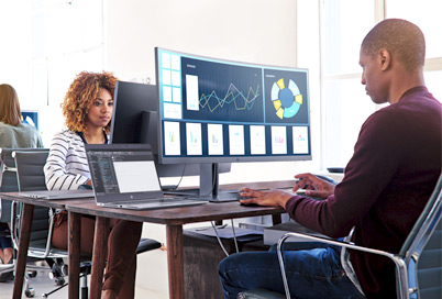 people in an office equipped with HP curved monitors