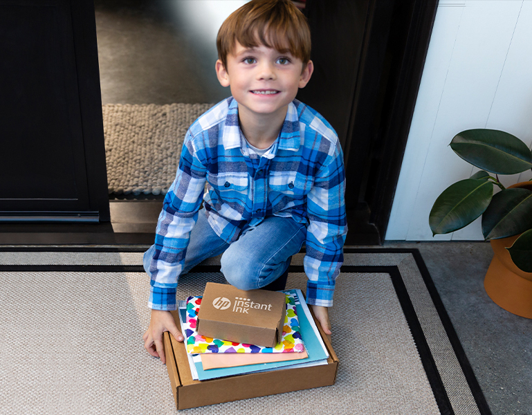 A child with a Instant Ink box